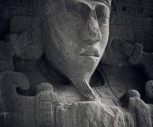 Ancient Mayan stone carving of a human face.
