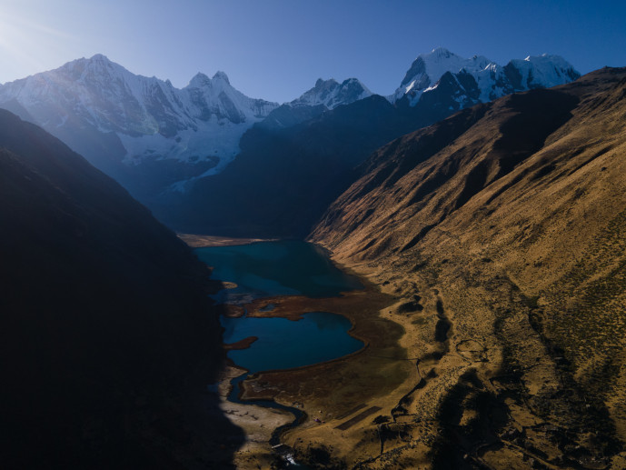 Aerial view of snow-capped mountains and alpine lakes.