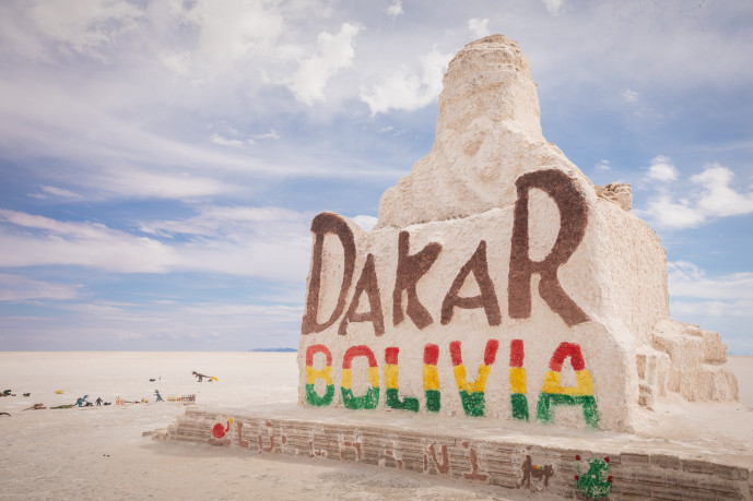 Dakar Bolivia sign on salt flats with clear sky.