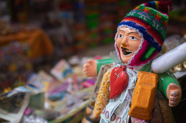 Colorful traditional figurine in a market setting.