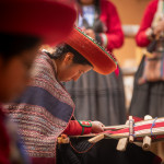 Peruvian woman weaving traditional textile.