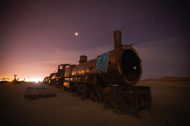 Abandoned train under starry night sky