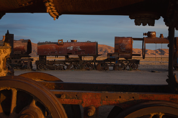 Rusty train graveyard at dusk