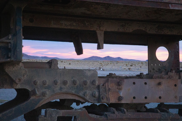 Coucher de soleil sur un vieux châssis de train dans le désert.