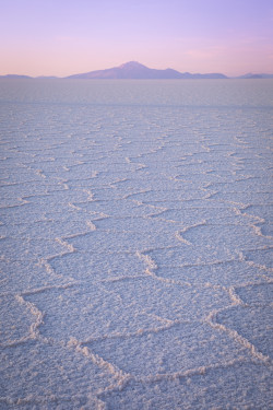 Salt flats with mountain at twilight.