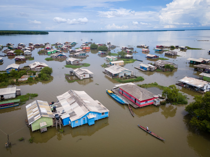 Aerial view of floating houses on a river.