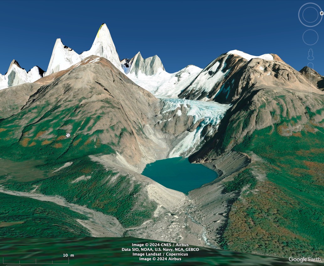 Mountain peaks with glacier and lake from above.