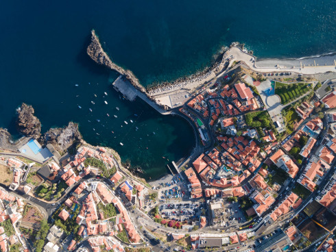 Aerial view of coastal Mediterranean town with marina.